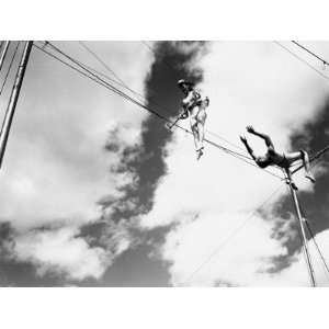  Male Trapeze Artist Hanging Upside Down Preparing To Catch 