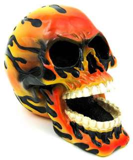 this wickedly awesome skull figure statue is glossy black with hand 