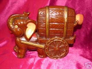   is a beautiful vintage terracotta japan elephant with a whiskey barrel