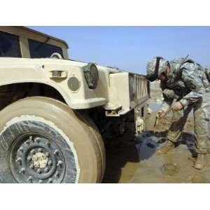  Staff Sergeant Unties a Rope to Tow a Humvee out of the 