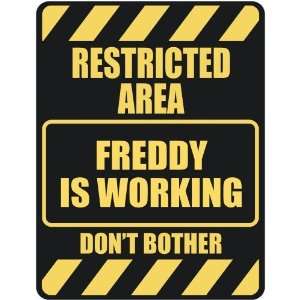   RESTRICTED AREA FREDDY IS WORKING  PARKING SIGN