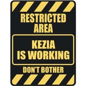   RESTRICTED AREA KEZIA IS WORKING  PARKING SIGN