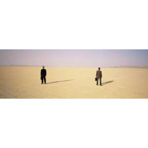 Two Businessmen Standing with their Briefcases in a Desert, Black Rock 