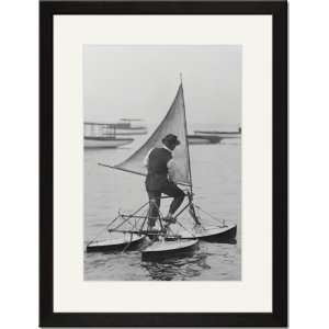   Print 17x23, Man stands on Sail Driven water Tricycle